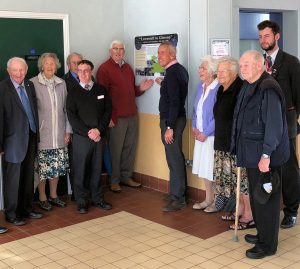 Members from the Lowestoft Evacuees Association, the Friends of Glossop Station along with the High Peak and Hope Valley Community Rail Partnership and Greater Anglia staff in front of the new panel.