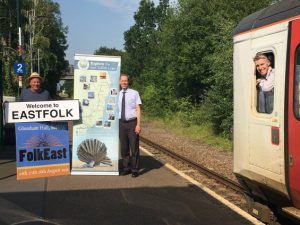 Members of FolkEast and the East Suffolk Lines Community Rail Partnership meet the train at Wickham Market rail station