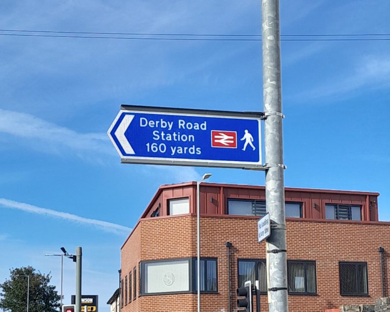 The new double sided sign point to Derby Road station at Foxhall Road