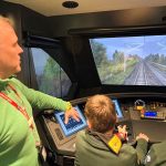 Scouts using the train driving simulator at Stratford