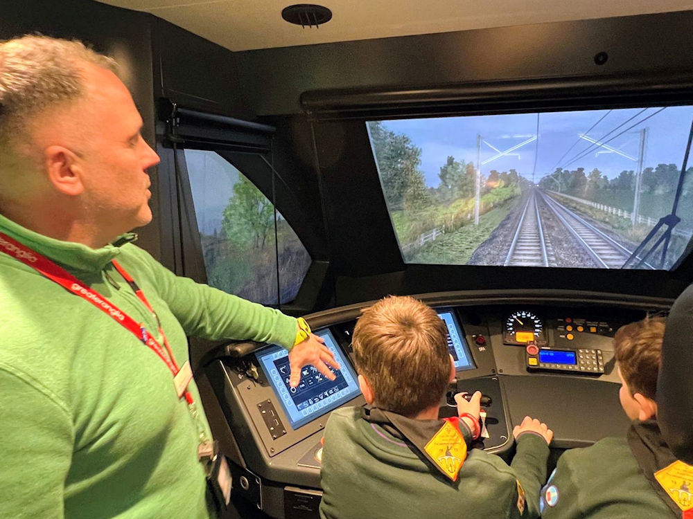 Scouts using the train driving simulator at Stratford